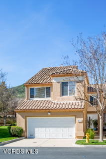 697 Lariate Lane, Unit A Simi Valley, CA 93065 - Photo 2 of 17 a front view of a house with a yard
