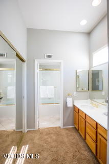 697 Lariate Lane, Unit A Simi Valley, CA 93065 - Photo 14 of 17 a spacious bathroom with a granite countertop sink and a mirror