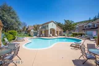 697 Lariate Lane, Unit A Simi Valley, CA 93065 - Photo 16 of 17 a view of a house with pool and chairs