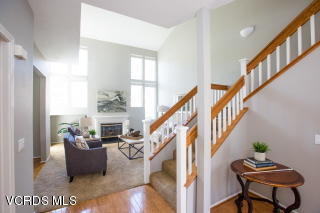 697 Lariate Lane, Unit A Simi Valley, CA 93065 - Photo 5 of 17 a living room with furniture stairs and a chandelier