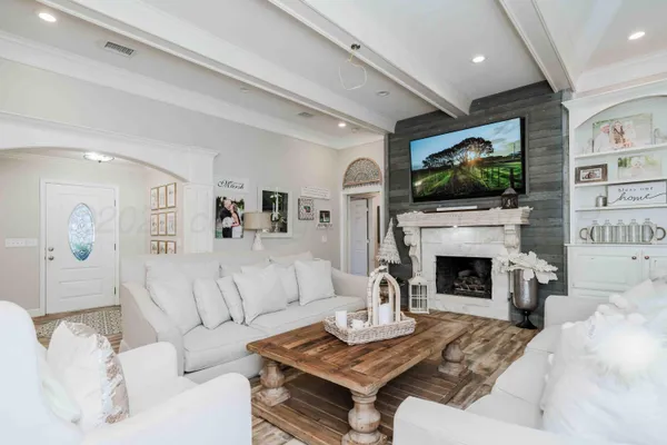 a living room with furniture a fireplace and a flat screen tv