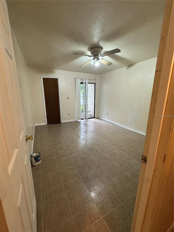 1515 Northwest 29 Road, Unit E3 Gainesville, FL 32605 - Photo 14 of 16 a view of a livingroom with a ceiling fan and window