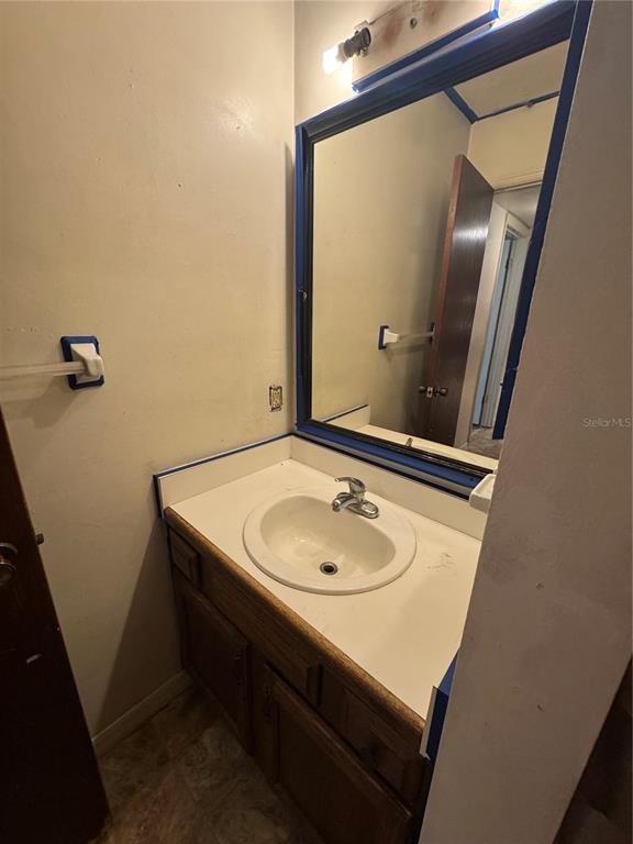 1515 Northwest 29 Road, Unit E3 Gainesville, FL 32605 - Photo 15 of 16 a bathroom with a sink a mirror and a vanity
