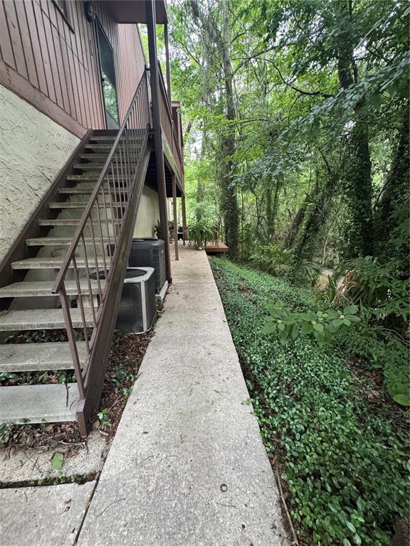 1515 Northwest 29 Road, Unit E3 Gainesville, FL 32605 - Photo 2 of 16 a view of stairs and yard