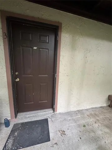 a backyard of a house with a yard and outdoor seating