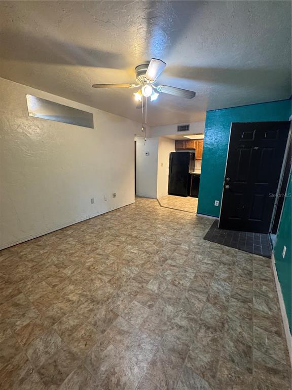 1515 Northwest 29 Road, Unit E3 Gainesville, FL 32605 - Photo 9 of 16 an empty room with closet and a ceiling fan