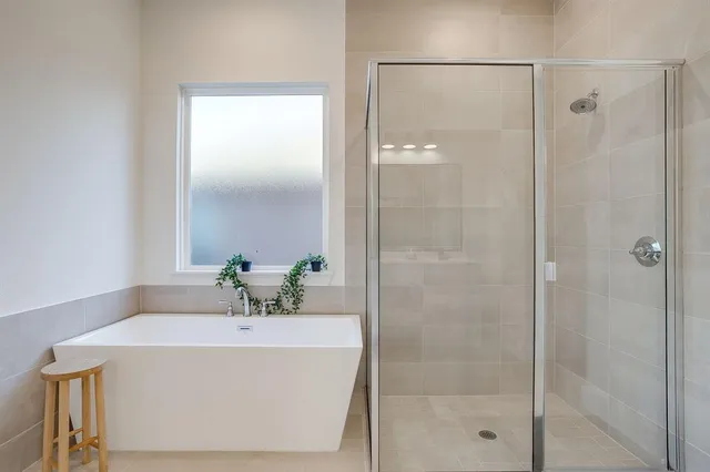 a bathroom with a bathtub and shower