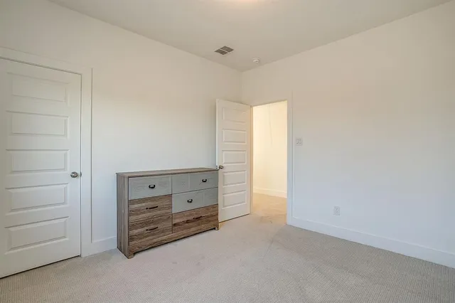 a room with a dresser and a window