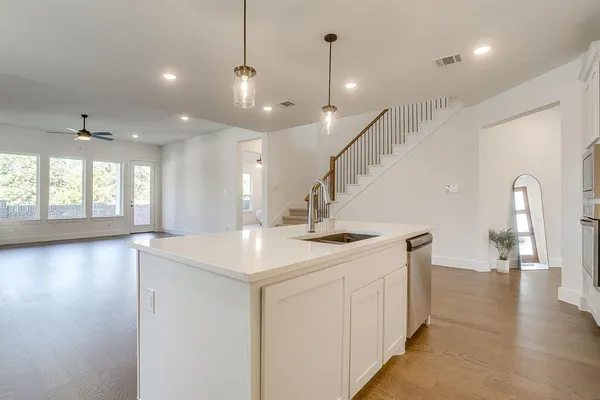 a kitchen with a sink and chandelier
