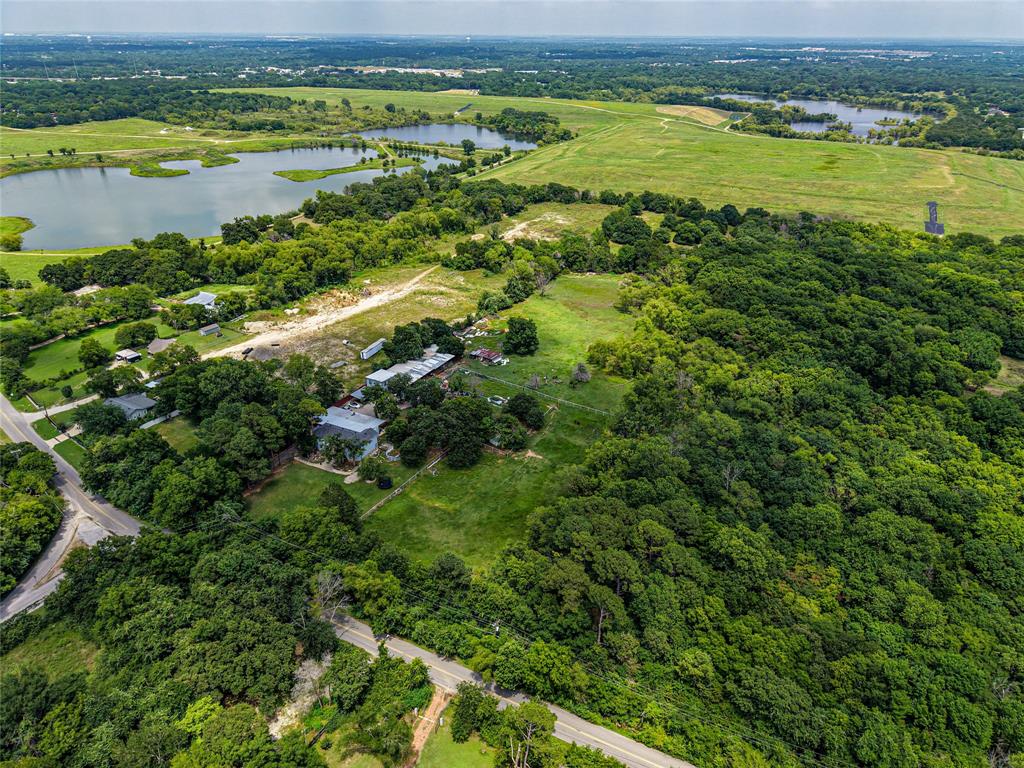 1900 Haymarket Road Dallas, TX 75253 - Photo 15 of 20 Expansive aerial perspective showcasing significant land acreage with multiple structures, mature tree cover, and a paved road frontage