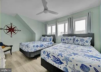 a bedroom with two beds and a window