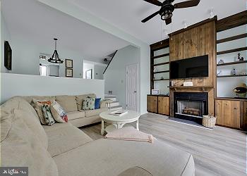 25 Henlopen Gardens, Unit 25 Lewes, DE 19958 - Photo 5 of 5 a living room with furniture and a flat screen tv