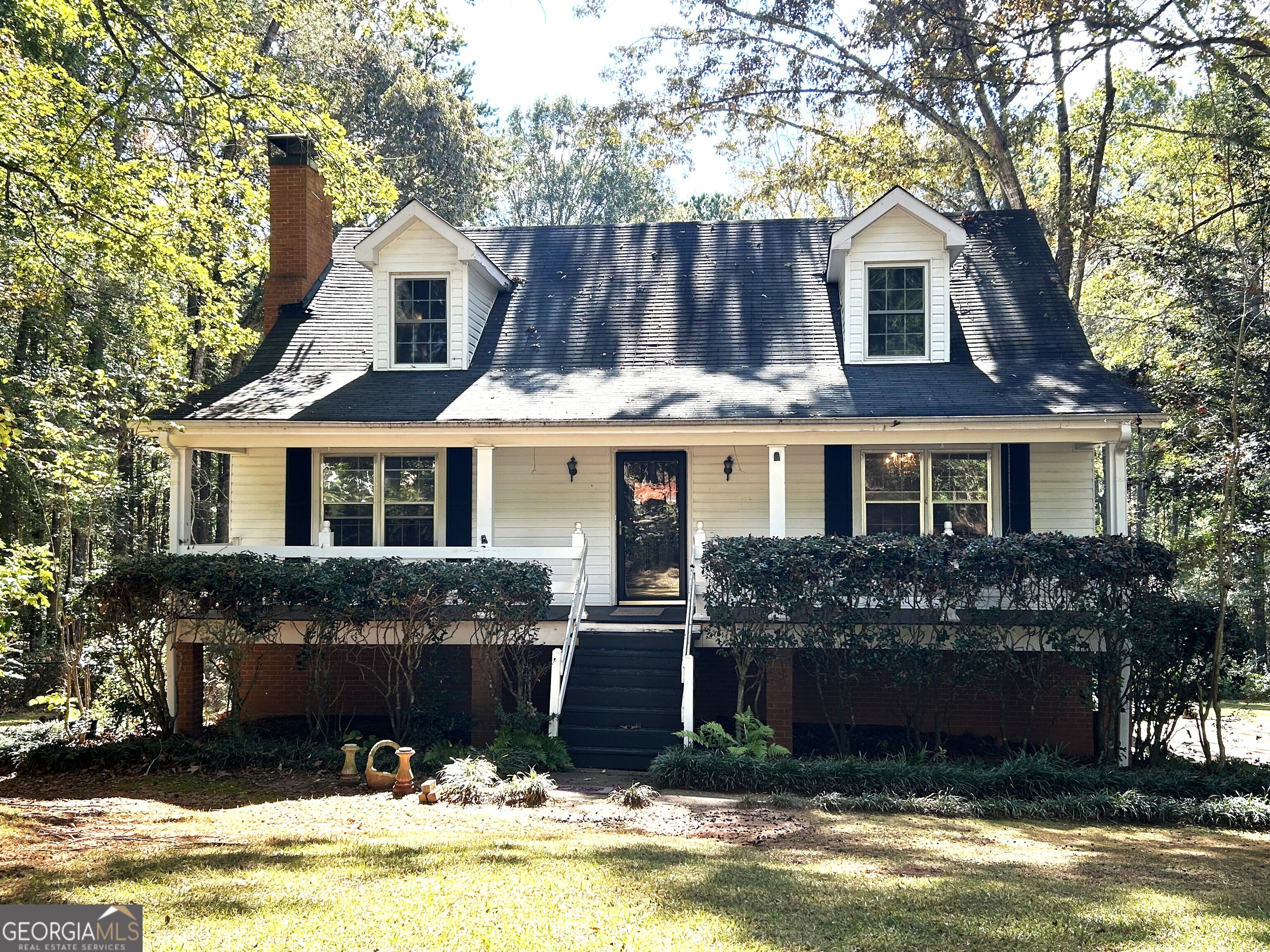 a front view of a house with a yard garage and swimming pool