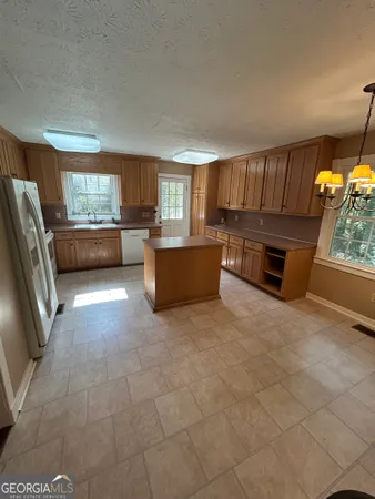 a kitchen with stainless steel appliances granite countertop a stove a refrigerator and a stove