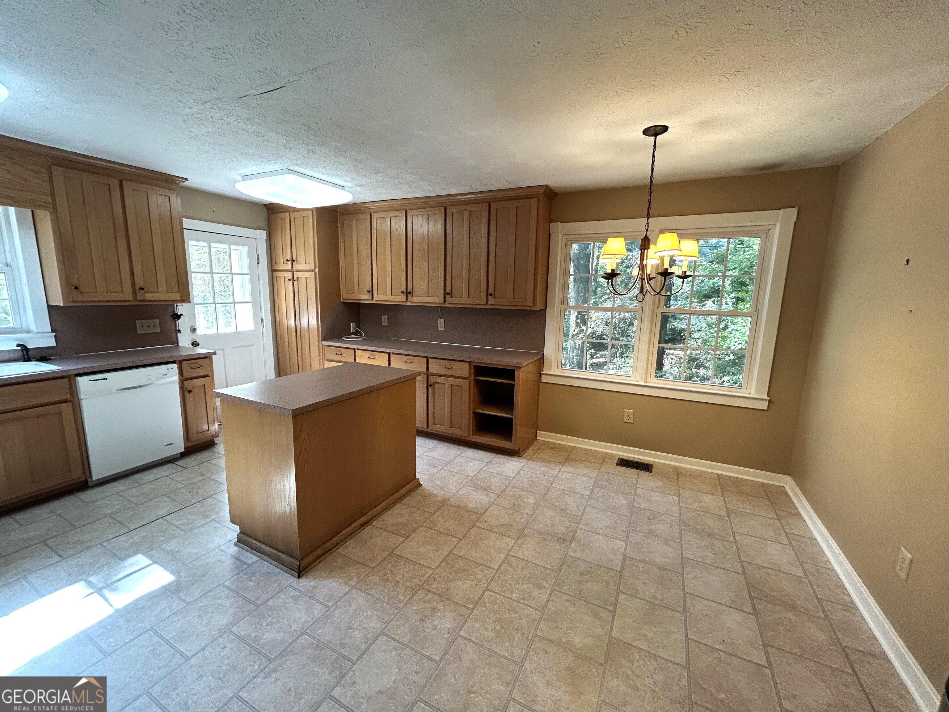 104 Spring Valley Drive LaGrange, GA 30240 - Photo 26 of 55 a kitchen with kitchen island granite countertop a stove a sink a counter space and cabinets