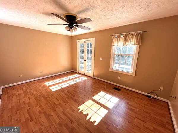 a view of a livingroom with a ceiling fan and window