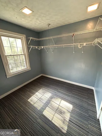 a view of a livingroom with a ceiling fan and window
