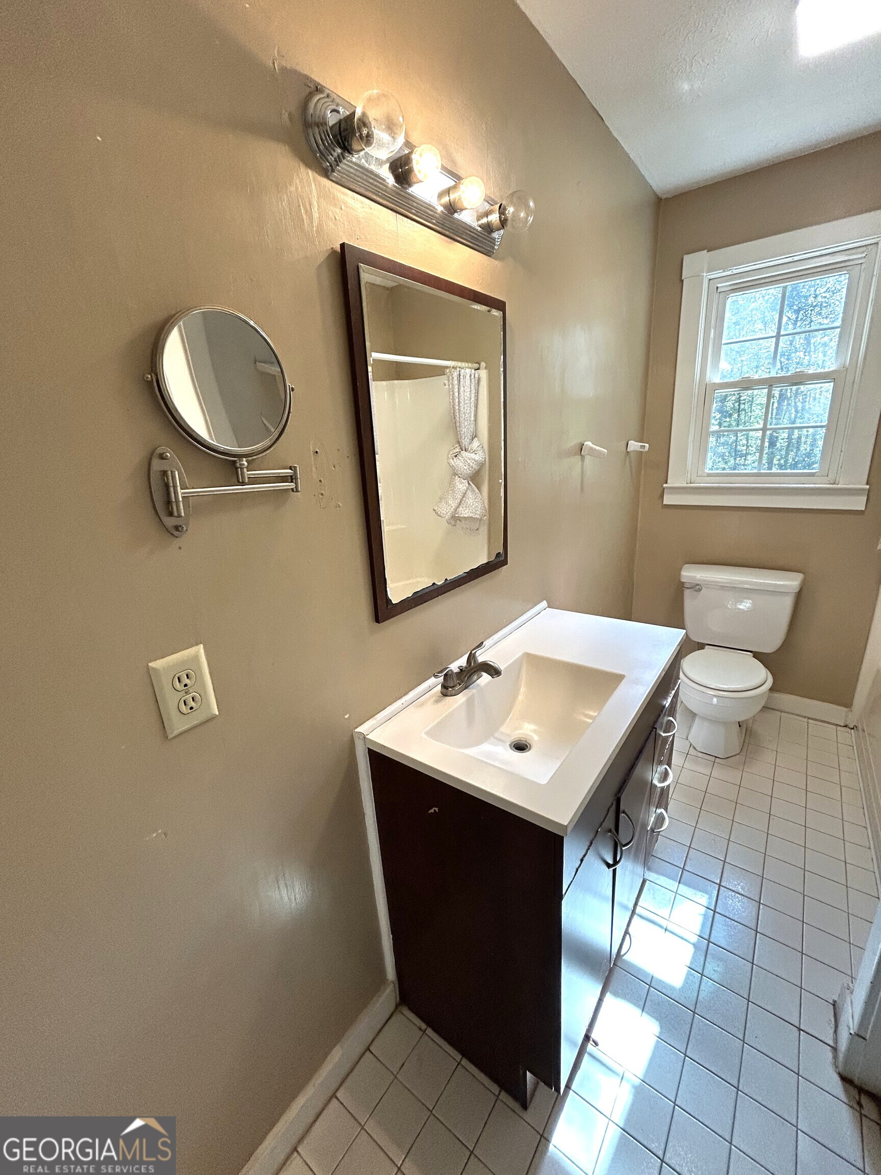 104 Spring Valley Drive LaGrange, GA 30240 - Photo 41 of 55 a bathroom with a sink a mirror and a shower