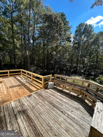 a view of deck with chairs and wooden floor
