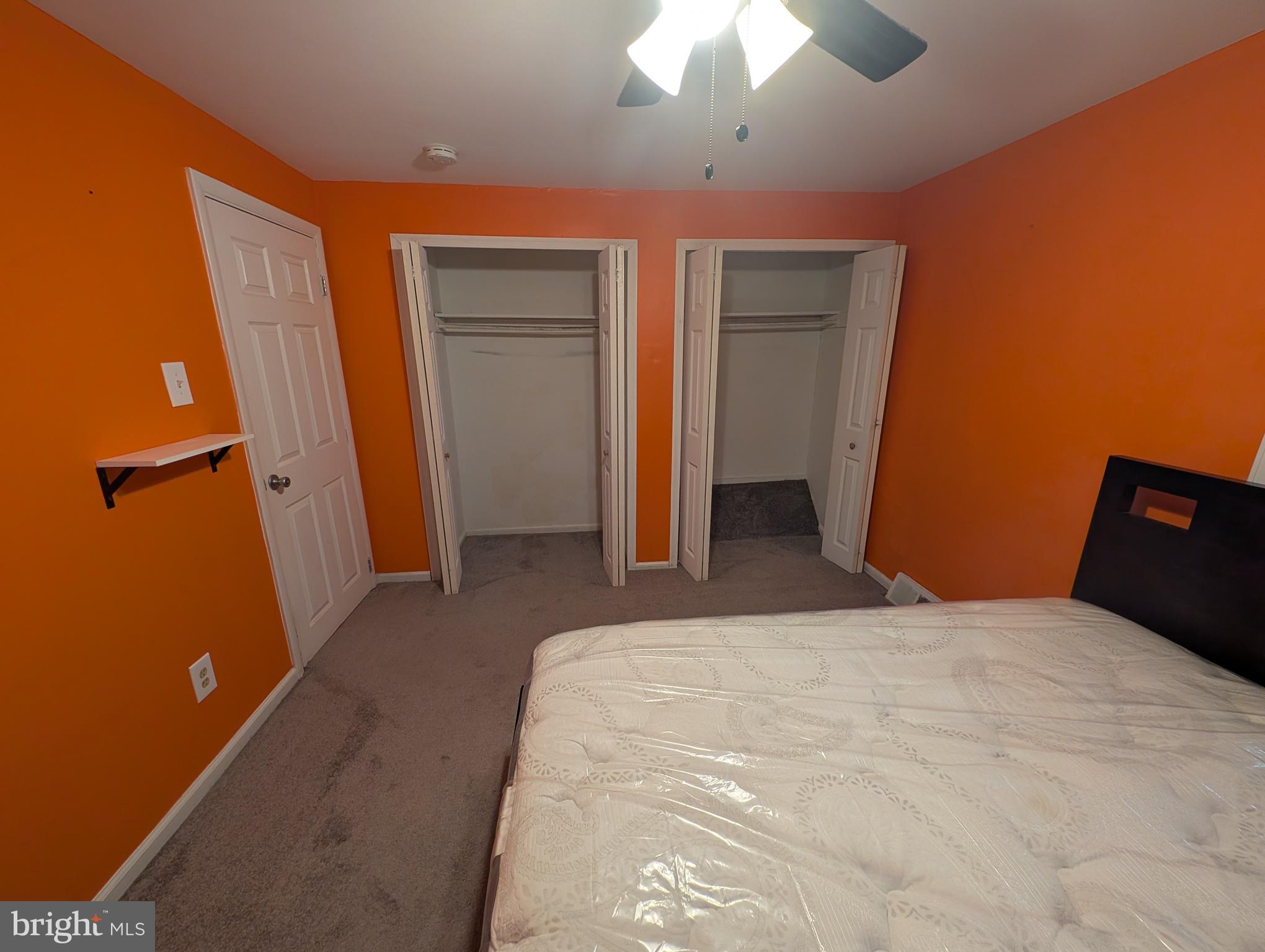 1412 Simpson Street Marcus Hook, PA 19061 - Photo 11 of 35 a bedroom with a bed and a chandelier