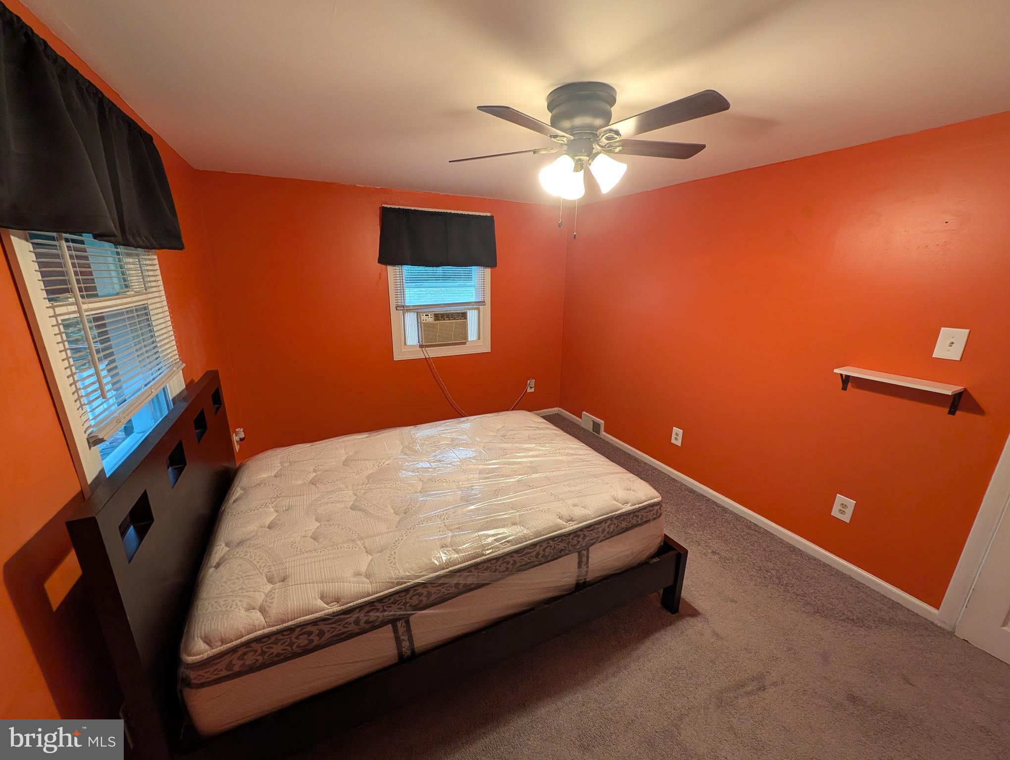 1412 Simpson Street Marcus Hook, PA 19061 - Photo 9 of 35 a bed sitting in a bedroom next to a window