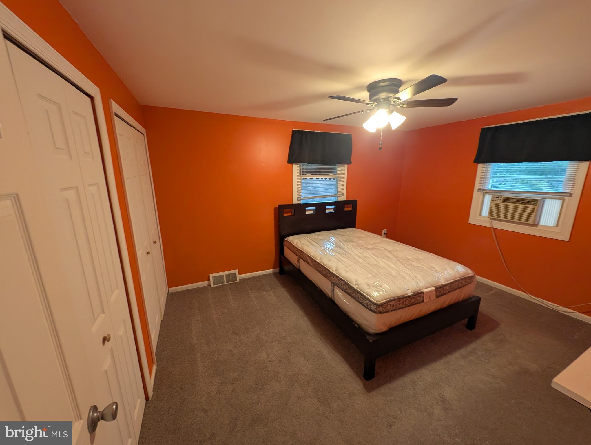 1412 Simpson Street Marcus Hook, PA 19061 - Photo 10 of 35 a bedroom with a bed and a chandelier