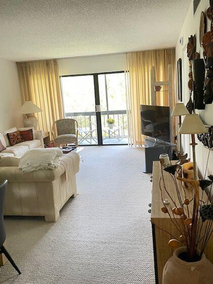 2500 Presidential Way, Unit 405 West Palm Beach, FL 33401 - Photo 11 of 28 a living room with furniture and a flat screen tv