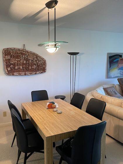 2500 Presidential Way, Unit 405 West Palm Beach, FL 33401 - Photo 12 of 28 a view of a dining room with furniture and chandelier