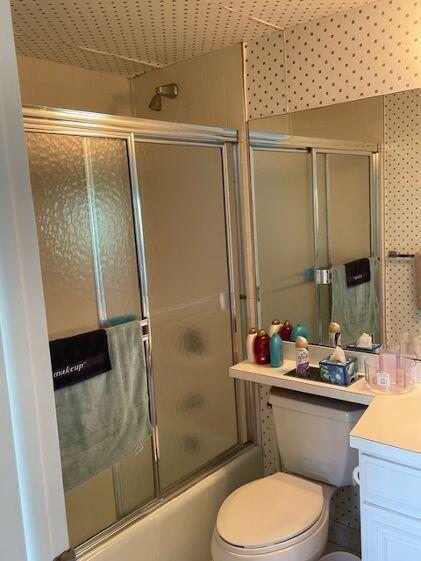 2500 Presidential Way, Unit 405 West Palm Beach, FL 33401 - Photo 13 of 28 a bathroom with a sink a toilet and shower