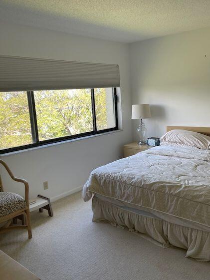 2500 Presidential Way, Unit 405 West Palm Beach, FL 33401 - Photo 14 of 28 a bedroom with a bed and window