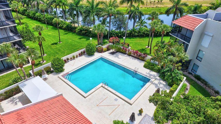 2500 Presidential Way, Unit 405 West Palm Beach, FL 33401 - Photo 22 of 28 a view of a backyard with plants and a patio