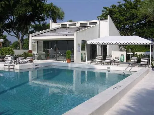 a view of a swimming pool with chairs
