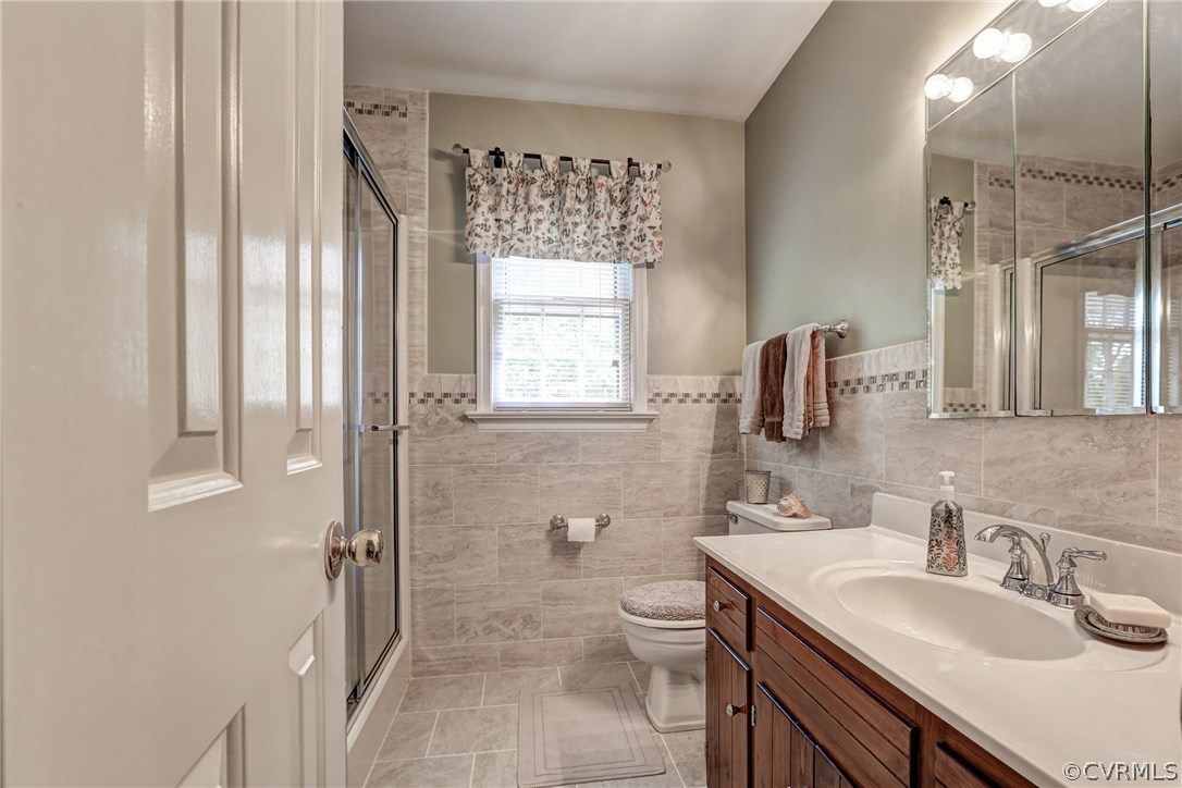 863 Watch Hill Road Midlothian, VA 23114 - Photo 28 of 38 a bathroom with a granite countertop sink toilet and shower