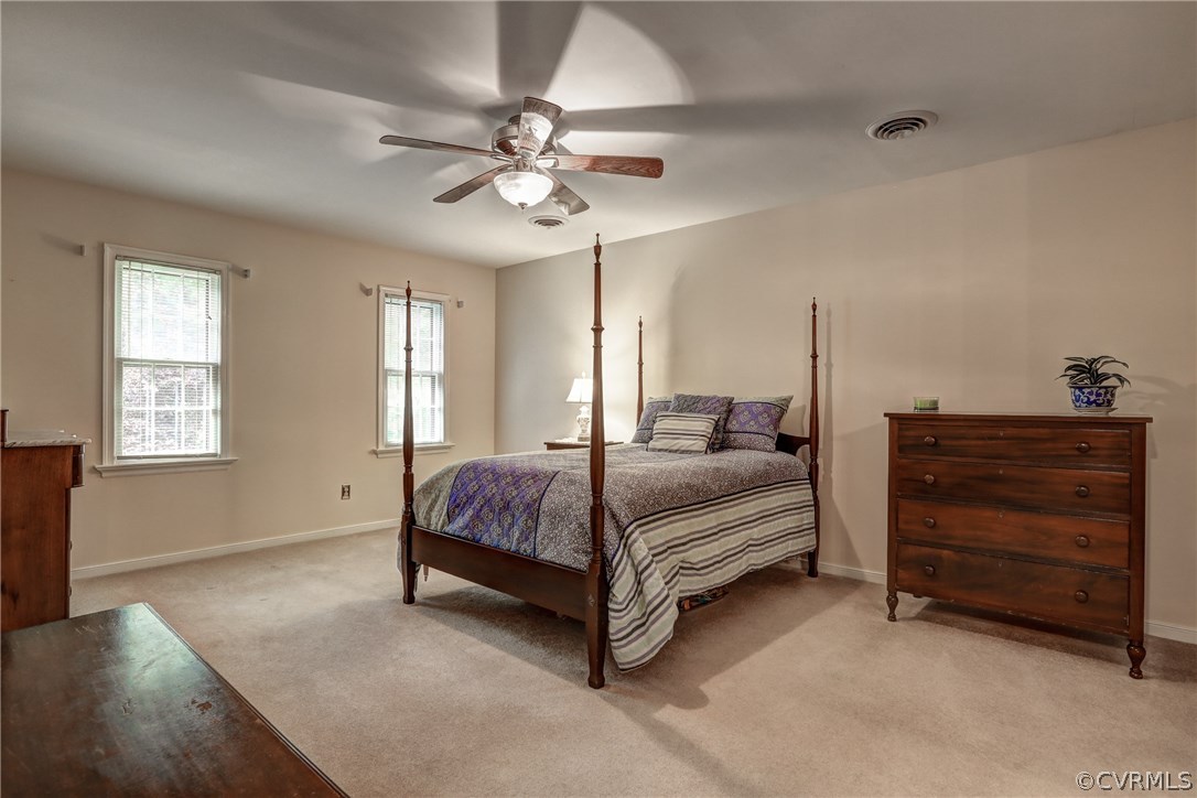 863 Watch Hill Road Midlothian, VA 23114 - Photo 31 of 38 a spacious bedroom with a bed chandelier and a window