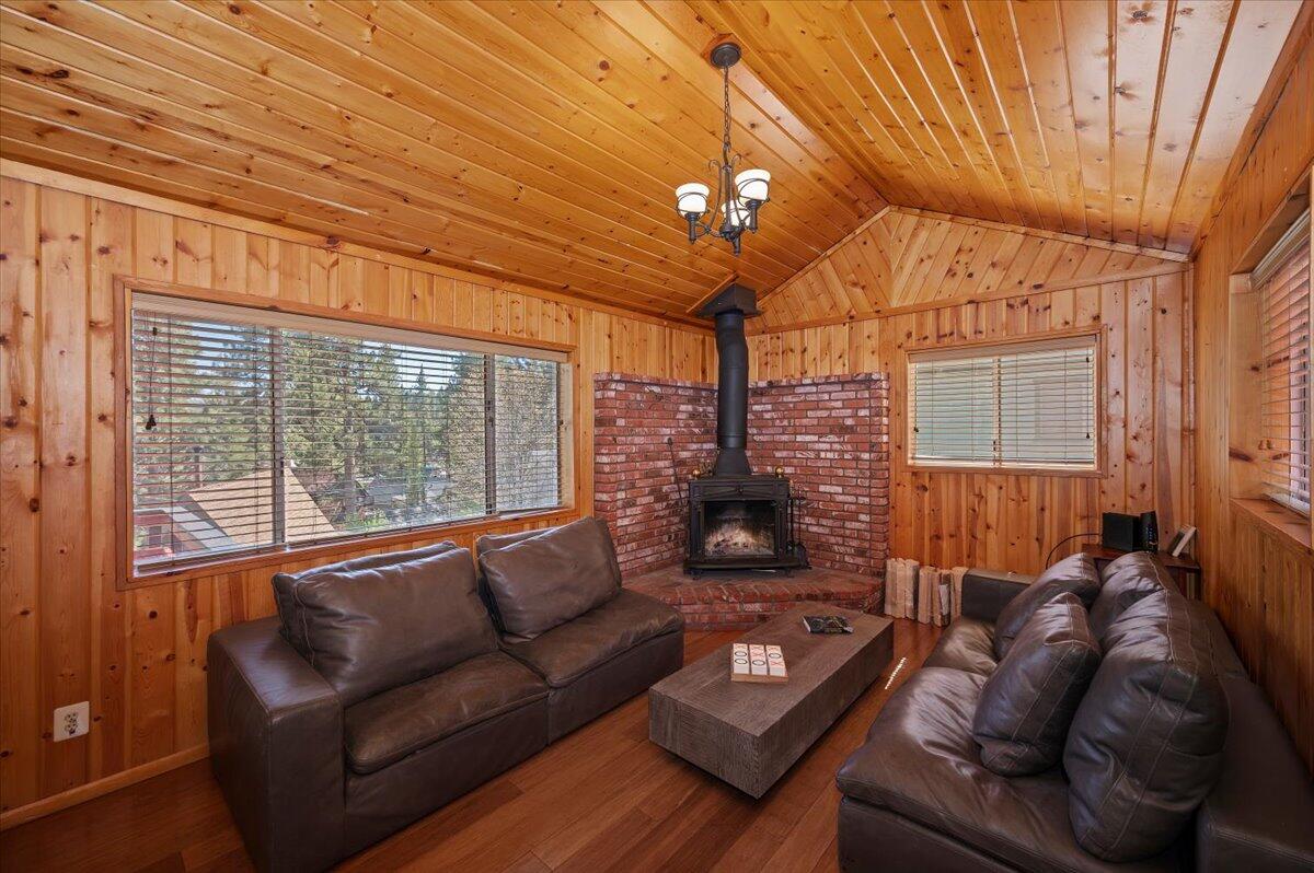 39187 Arapahoe Road Fawnskin, CA 92333 - Photo 9 of 33 a living room with furniture a ceiling fan and a large window