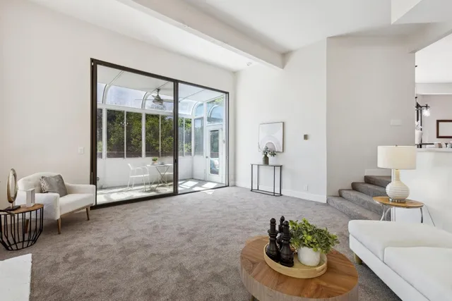 a living room with furniture and a potted plant