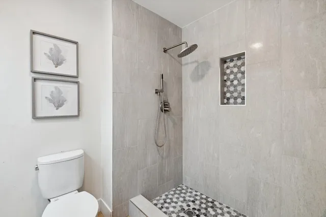 a bathroom with a toilet sink and shower