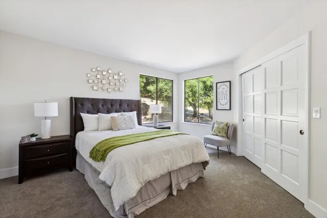 a spacious bedroom with a bed and a couch