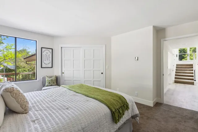 a bedroom with a large bed and a window