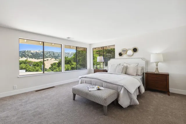 a bedroom with a bed and a large window