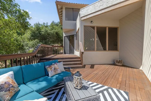 an aerial view of a house with a yard and large trees