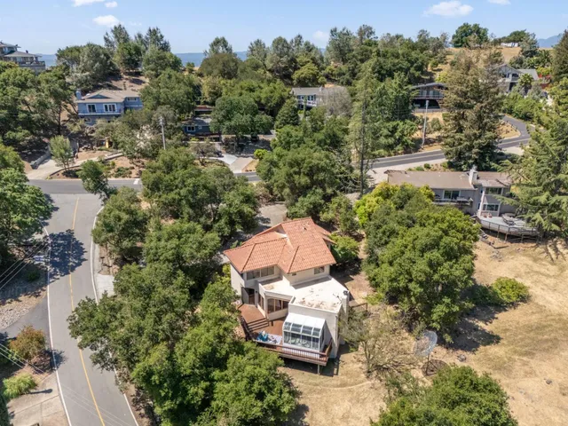 an aerial view of a house with a yard