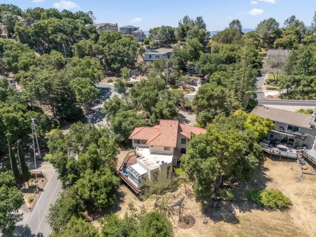an aerial view of a house with yard swimming pool and outdoor seating