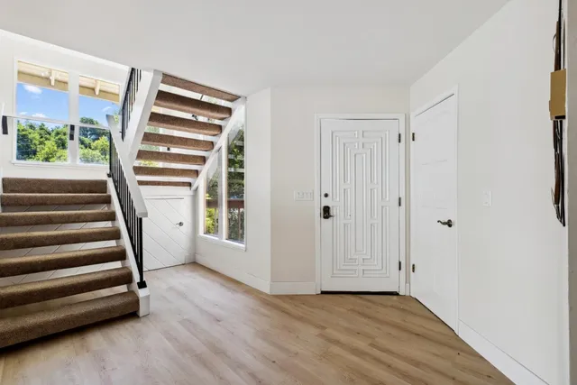 a view of a livingroom with wooden floor and window