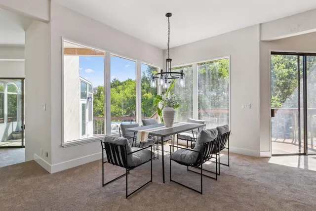 a view of a dining room with furniture window and outside view