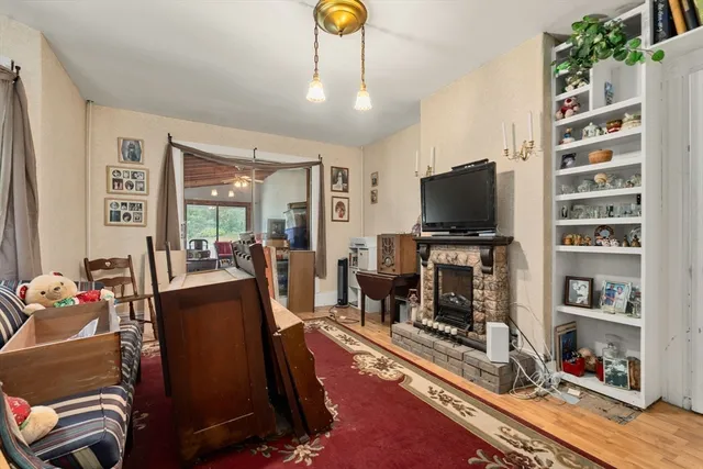 a living room with furniture a flat screen tv and gym equipment