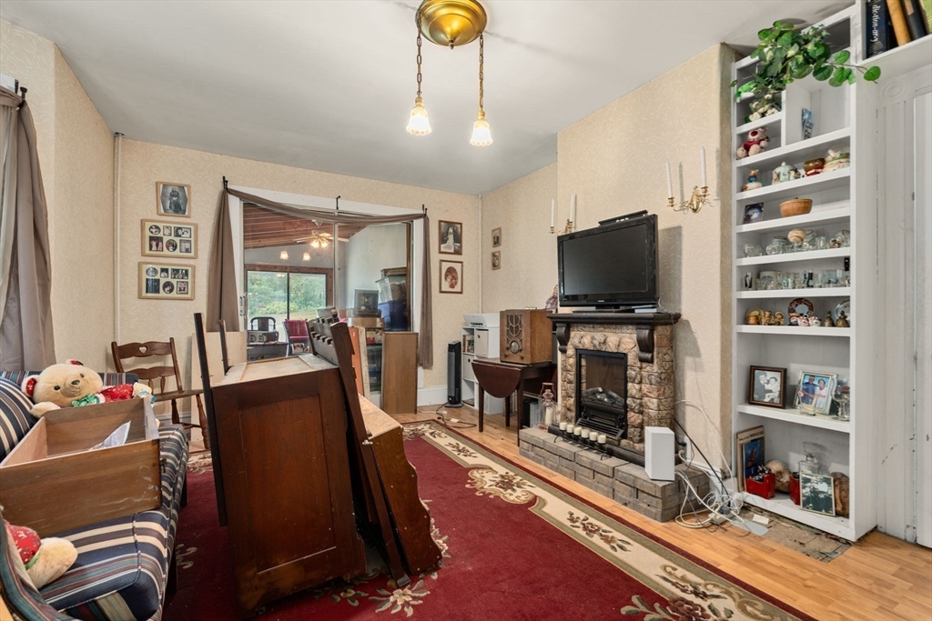 130 Tower Road Lincoln, MA 01773 - Photo 8 of 21 a living room with furniture a flat screen tv and gym equipment