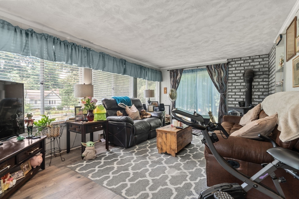 130 Tower Road Lincoln, MA 01773 - Photo 10 of 21 a living room with furniture a flat screen tv and a window
