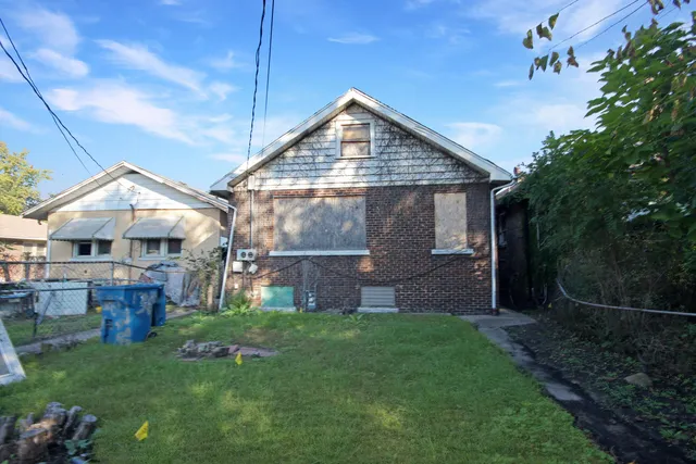 a view of street with small yard and large trees