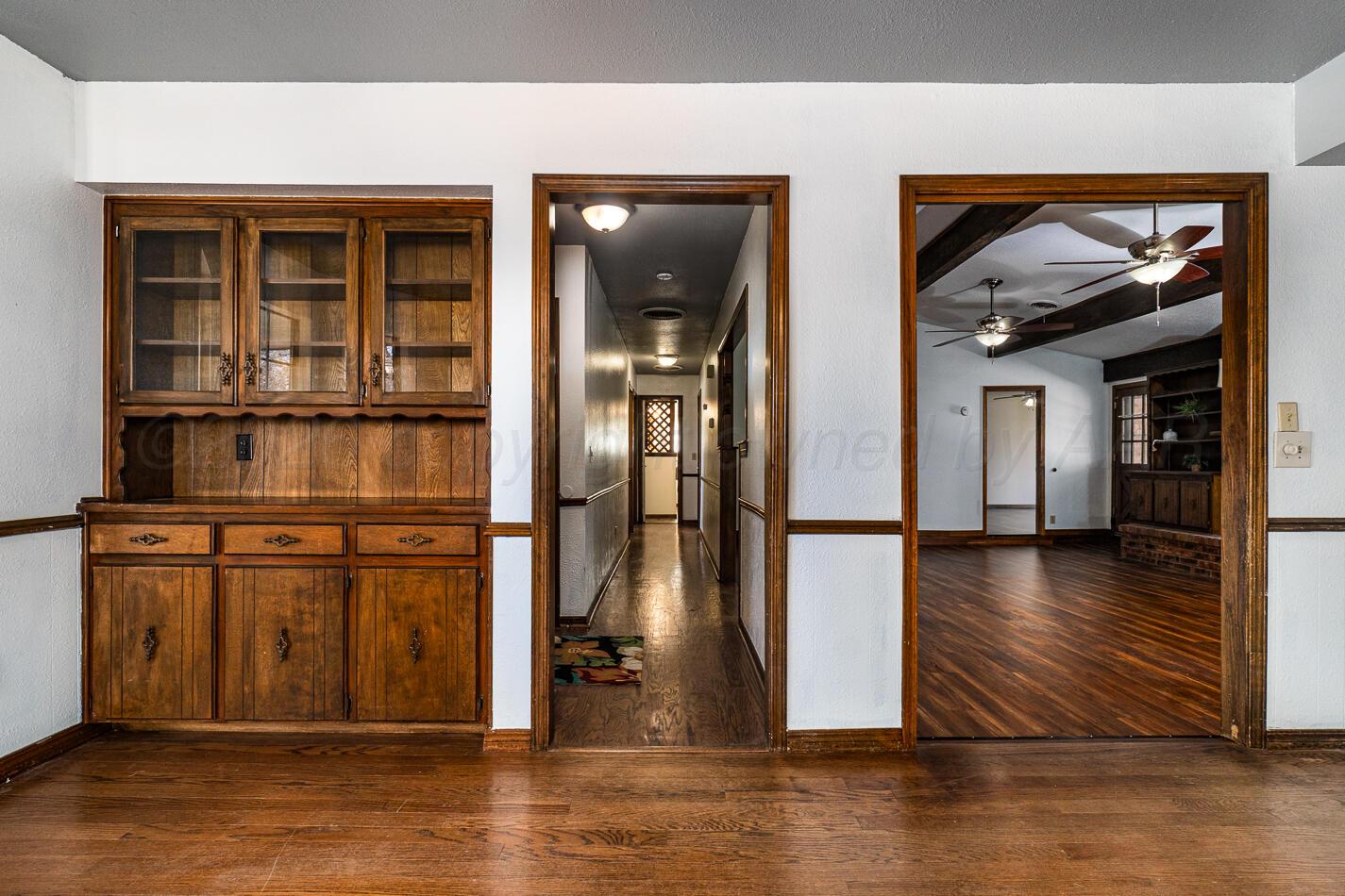 7803 Farrell Drive Amarillo, TX 79121 - Photo 11 of 29 a view of a hallway with wooden floor and dining room
